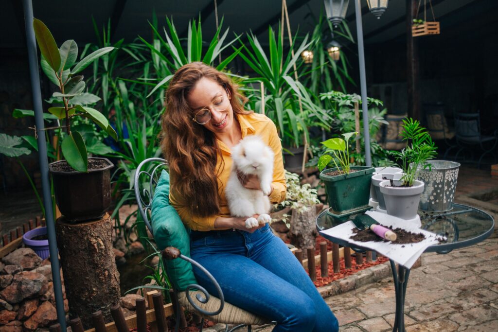 woman holding pet rabbit .